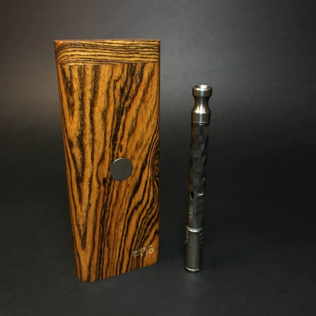 futostash XL for dynavap stood upright on grey background with dynavap OmniVap standing next to it