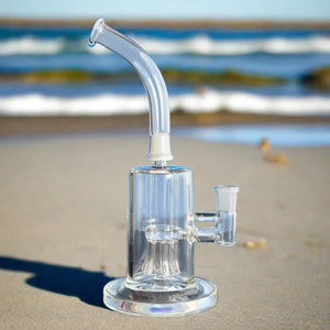 sneaky pete jellyfish pipe glass rig sat on sandy beach