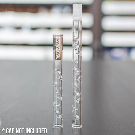 2 sneaky pete glass add-a-cap accessories one with a dynavap cap and one without stood upright on grey surface