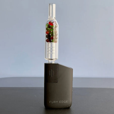 sneaky pete xl rocket stem paired with  healthy rips fury edge  vaporizer on grey surface