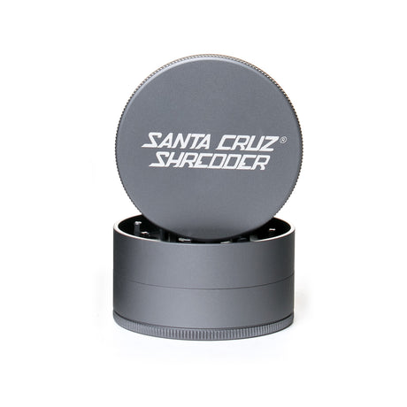 large matt Grey santa cruz shredder herb grinder with the lid section sitting on top of the base. Santa Cruz logo on lid.