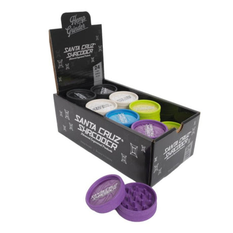 box of santa cruz shredder hemp made 2 piece herb grinders in a range of colours set on white background