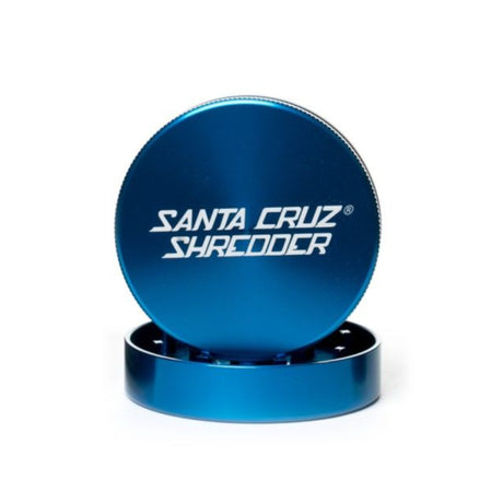 large gloss blue santa cruz 2 piece herb grinder with top section sat atop the bottom section set on white background