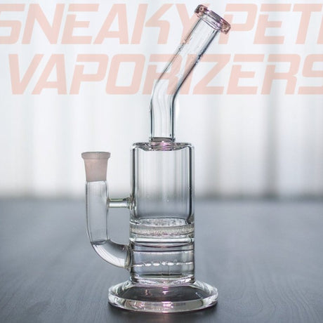 sneaky pete the buzz glass rig sat on grey surface