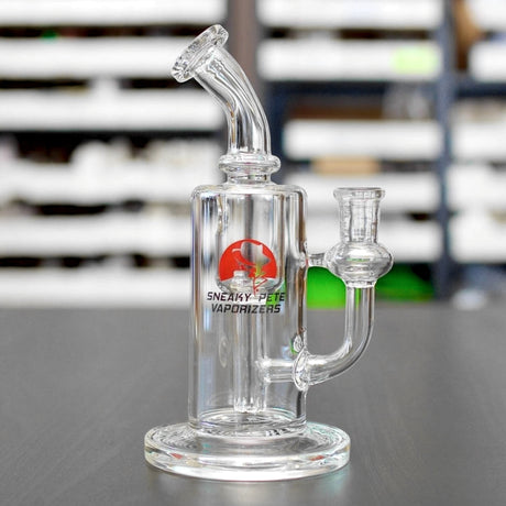 sneaky pete gentleman recycler glass rig sat on grey surface