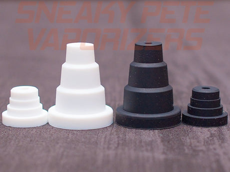 2 sneaky pete master adapters 1 black and 1 white in 2 pieces on grey surface