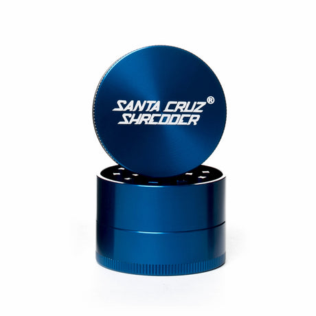 gloss Blue 3 piece santa cruz shredder herb grinder with the lid section sitting on top of the base. Santa Cruz logo on lid.