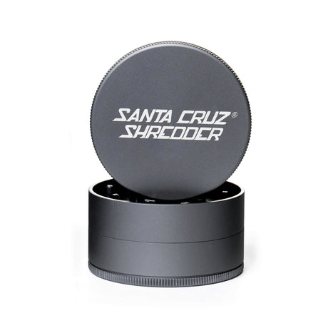 Grey 3 piece santa cruz shredder herb grinder with the lid section sitting on top of the base. Santa Cruz logo on lid.