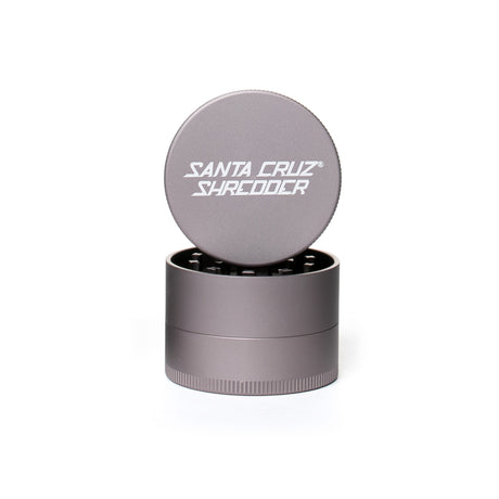 medium matt grey 3 piece santa cruz shredder herb grinder with the lid section sitting on top of the base. Santa Cruz logo on lid.