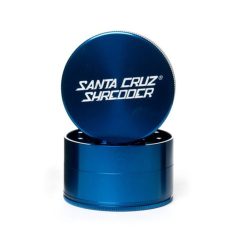 large gloss blue 4 piece santa cruz shredder herb grinder with the lid section sitting on top of the base. Santa Cruz logo on lid.