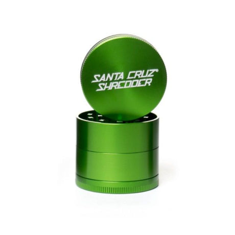 medium gloss Green 4 piece santa cruz shredder herb grinder with the lid section sitting on top of the base. Santa Cruz logo on lid.