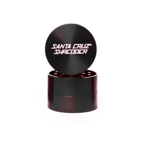 medium gloss black 4 piece santa cruz shredder herb grinder with the lid section sitting on top of the base. Santa Cruz logo on lid.